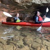 Kayaker paddling near rock formations